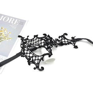 Detail of elegant black lace party mask with ribbon tie on a minimalist background