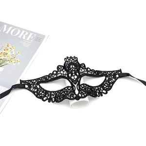 Detailed close-up of intricate black lace masquerade mask with ornate floral embroidery