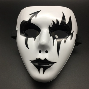 Detail view of a white Halloween mask with black hand-painted artistic patterns and straps