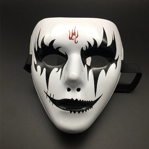 Detail showing hand-painted black eye patterns and red flame totem on white full face mask