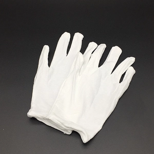 Detailed view of the soft white cotton fabric and texture of the ceremonial gloves