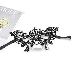 Close-up of black lace masquerade mask with butterfly patterns and ribbon ties