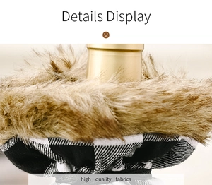 Macro view of Christmas wine bottle cover with faux fur and black and white plaid fabric