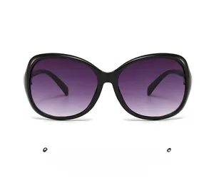 Close-up of glossy black oval sunglasses frame with purple gradient lenses
