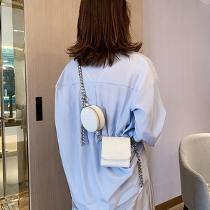 White crocodile pattern crossbody bag set with chunky silver chain on model back