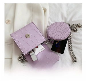 Detail view of purple crocodile texture crossbody bag with silver chain and internal capacity