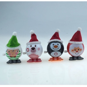 Close-up of four Christmas wind-up toys including elf, bear, penguin and Santa figures