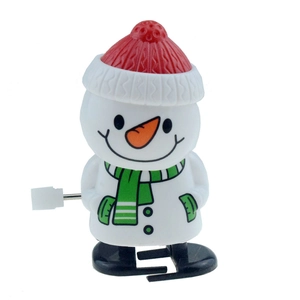 Detail of wind-up snowman toy with red knitted hat and green striped scarf