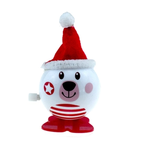 Detail of wind-up white cartoon bear toy with red Christmas hat and striped belly