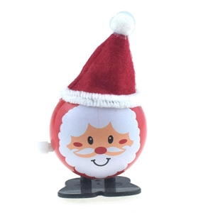 Detail of wind-up Santa Claus toy with red felt hat and mechanical walking movement