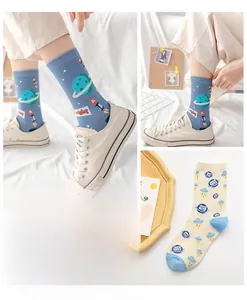Close-up of cotton socks with astronaut planets and cartoon monster patterns