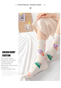 Detail of white cotton socks featuring cartoon rocket and UFO motifs in a home setting