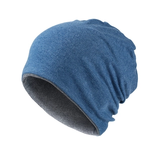 Close-up of the double-layered knitted beanie featuring navy exterior and gray lining texture