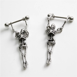 Detailed macro view of vintage silver skull skeleton barbell body piercing jewelry