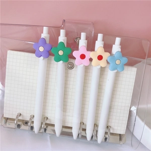 Detail view of 0.5mm white gel pens with colorful flower charms in a cute binder