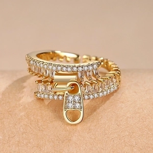 Adjustable gold plated zipper ring featuring heart detail and rows of cubic zirconia