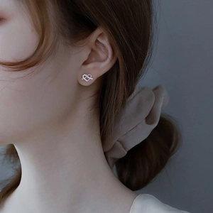925 sterling silver heart-shaped stud earrings with sparkling cubic zirconia on model