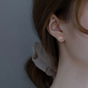 Elegant 925 sterling silver heart-shaped gold stud earrings with white zircon on model