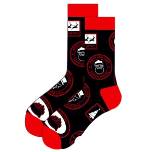 Close-up of black and red Christmas socks with Santa Claus and reindeer holiday patterns