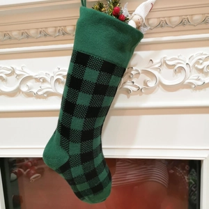18 inch green buffalo plaid knitted Christmas stocking hanging on a white fireplace
