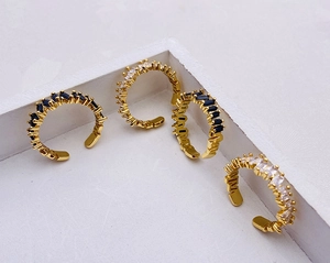 Macro shot of gold adjustable rings with rectangular black and white crystal zircon