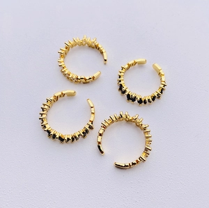 Detailed top view of four adjustable gold-plated rings with inlaid black zircon stones