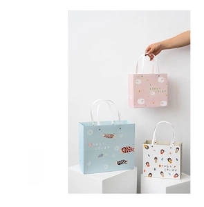 Detailed view of three festive Japanese style paper gift bags with cute rabbit and koi patterns