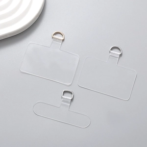 Close-up of clear PVC phone lanyard tether pads with gold and silver D-ring metal connectors