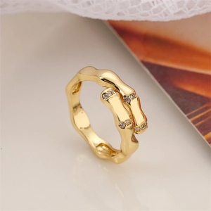 Macro shot of gold-plated bamboo joint ring featuring micro-pave cubic zirconia accents