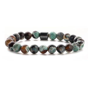 Detailed close-up of beaded bracelet with tiger eye, malachite, and volcanic stone