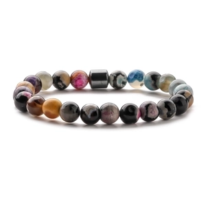 Detailed close-up of 8mm natural stone beads and magnetic hematite cylinder on mens bracelet