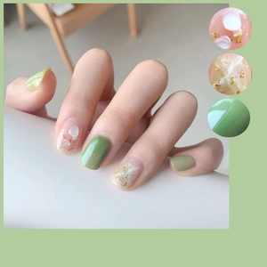 Green marble press-on nails with shell pieces and gold foil accents for a clean look