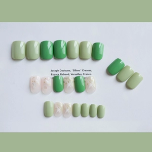 Artistic press-on nail set featuring green marble patterns with shell and gold foil accents