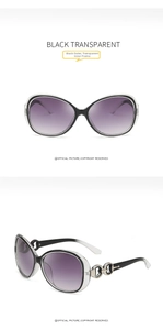 Detail of oversized oval sunglasses with black transparent frames and purple gradient lenses
