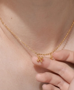 Minimalist 18K gold-plated titanium necklace with beaded cross pendants and layered chain