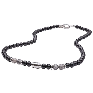 Detailed macro view of black obsidian and grey tiger eye beaded necklace with silver toggle
