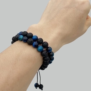 Detail of double-layer tiger eye and lava stone bracelet with adjustable braided cord