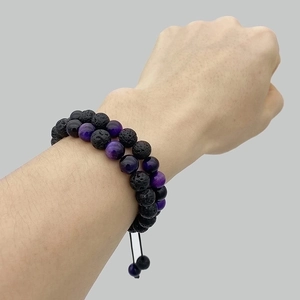 Detailed view of layered 8mm green tiger eye and lava rock essential oil bead bracelets