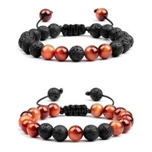 Close-up of 8mm green tiger eye and lava stone beaded bracelets with adjustable cord
