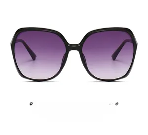 Detailed close-up of oversized square sunglasses featuring purple gradient lenses and black frames