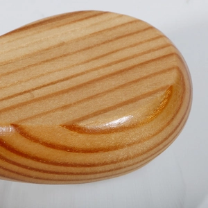 Macro detail of the smooth polished beech wood handle showing natural grain and finish