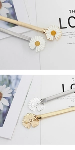 Detailed view of elastic metal waist belts with white daisy buckles in gold and silver