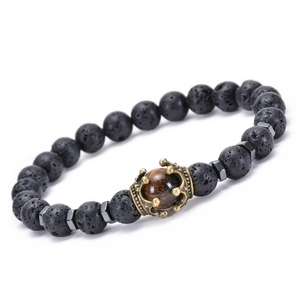 Macro detail of natural tiger eye stone with golden crown and black lava rock beads