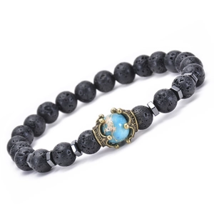 Detail of porous black volcanic rock beads and vintage metal crown on elastic bracelet