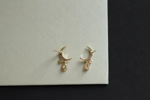 Detailed close-up of 14K gold plated crescent moon earrings with cubic zirconia drops