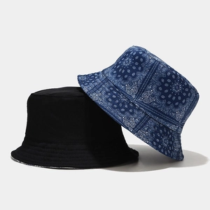 Reversible bucket hat set in solid black and blue paisley pattern for sun protection