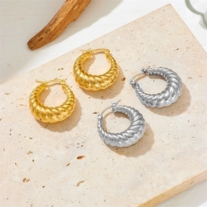 Polished gold and silver spiral hoop earrings in vacuum-plated stainless steel