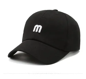 Detail shot of the 3D white M embroidery on a black cotton twill baseball cap