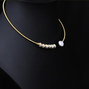 Detail of handmade gold wire collar necklace with natural white freshwater pearls