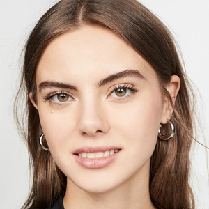 Close-up of a model wearing minimalist glossy S925 sterling silver hoop earrings